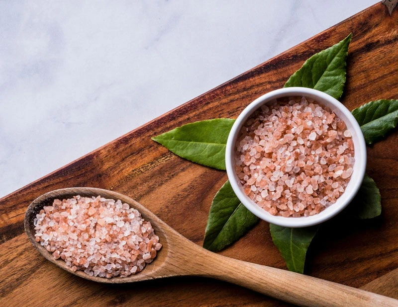 pink Himalayan salt in spoon jar