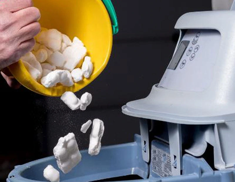 water softener salt pellets poured into softener unit