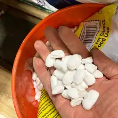 water softener salt pellets in hand
